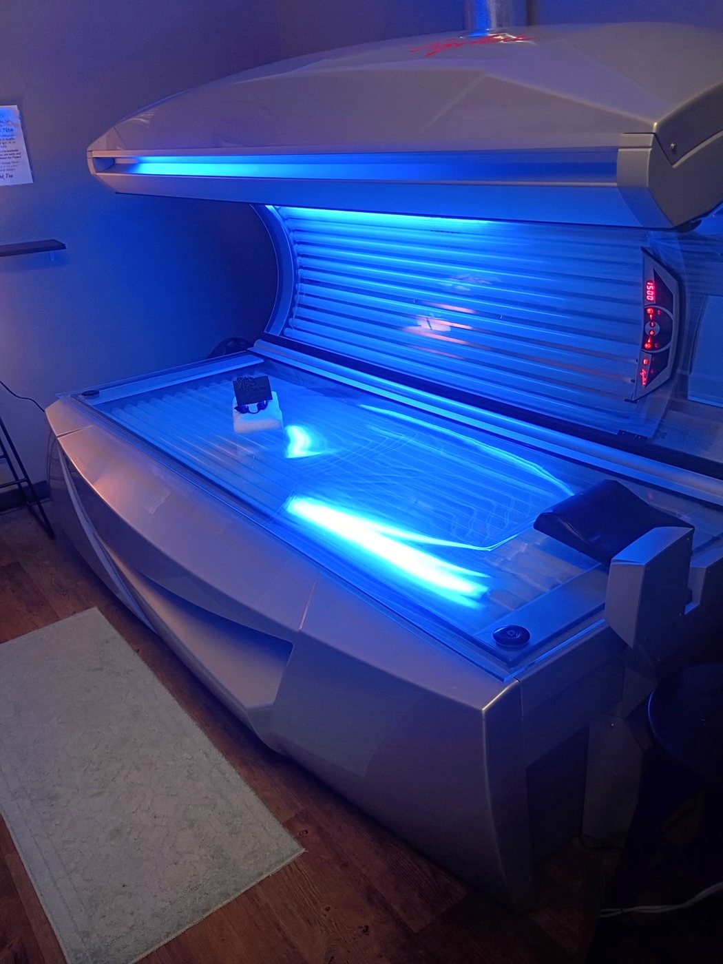 Blue-lit tanning bed at Bronze & Beauty Salon